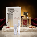 Barakkat Rouge 540 with clear-glass travel sprays in a burgundy-and-gold setting