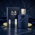 Parfums de Marly Layton bottle and box with plain clear-glass travel sprays in a navy-and-silver setting